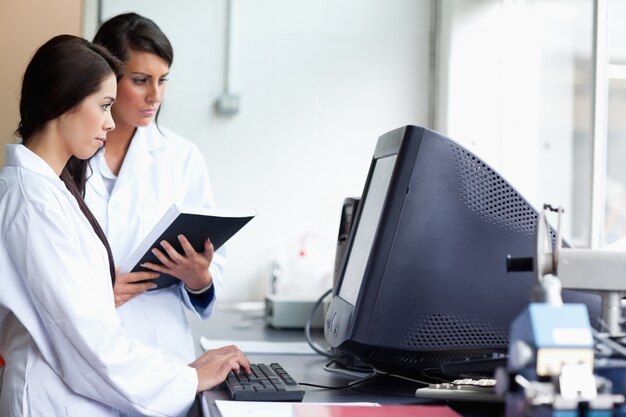 Female scientists using a monitor