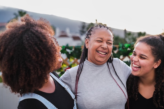 Female sector of the family laughing together on the terrace of the house and having a fun time