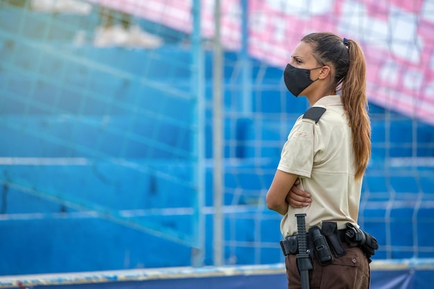 写真 屋外イベントで目視調査する女性警備員