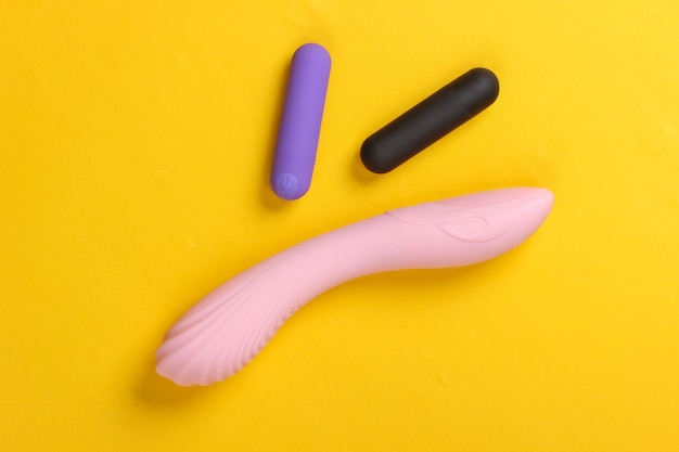 Female sex toys on yellow. Sex stimulation