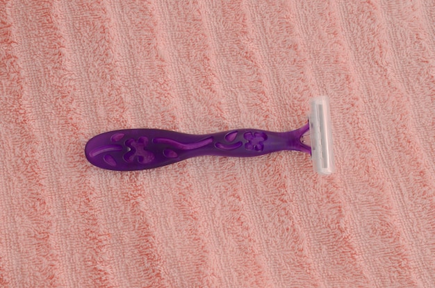 The female shaver glides smoothly over the smooth surface representing care and practicality in the beauty ritual