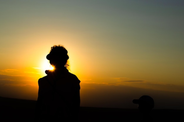 Female silhouette against the background of the sun