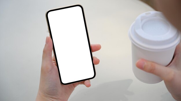 Female sits in the coffee shop and using smartphone to communicate with her friends phone mockup