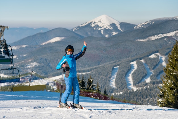 female skier showing thumbs up while skiing