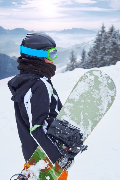 Female snowboarder on the mountain with snow