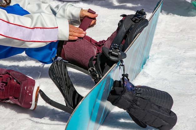 Female snowboarder wears snowboard equipment