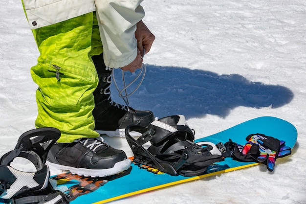 Female snowboarder wears snowboard equipment