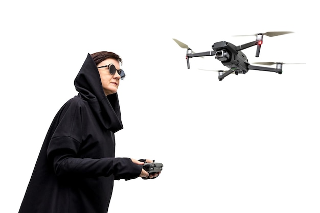 Female spy in black clothes and round glasses with a drone isolated on white background