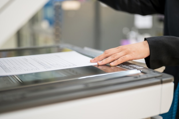 Female staff is copying the photocopier in the office