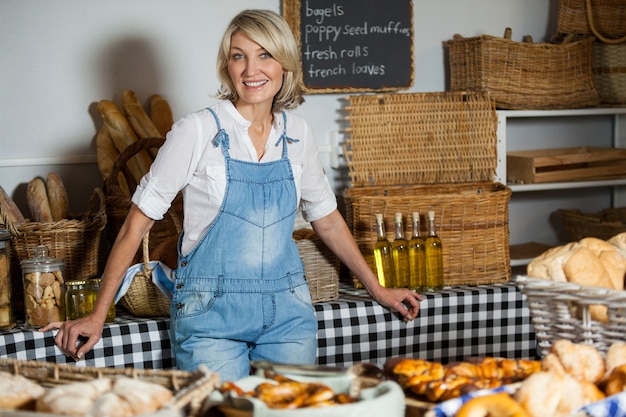 Female staff standing at bakery section