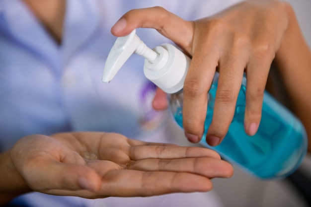 Female staff wash their hands with alcohol gel before working in the hospital. To prevent the virus, Covid-19, the concept of health care