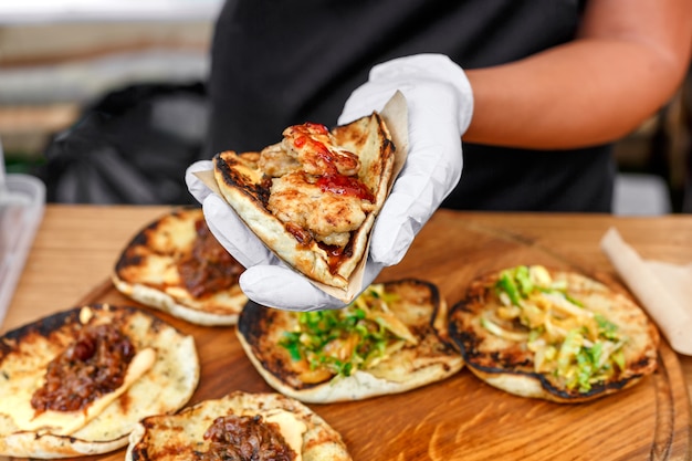 Female street vendor hands making taco