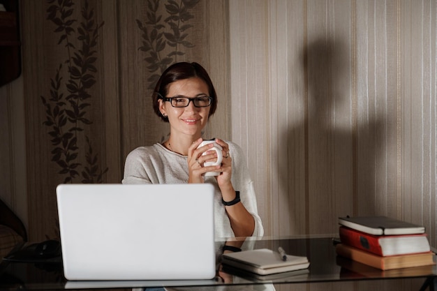 Female student freelancer working at home on a task