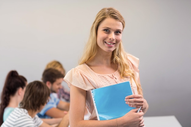 Female student holding folder in college