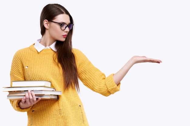 Female student holding pile of books