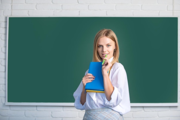 Female student on lesson lecture in classroom at high school or college female student taking notes