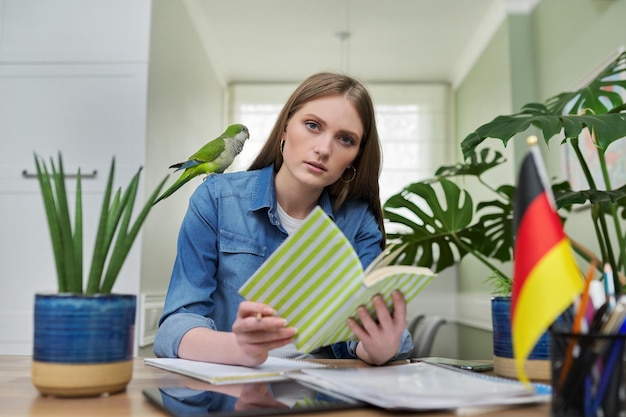 Photo female student looking talking to webcam studying german online