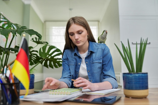 Female student looking talking to webcam studying German online