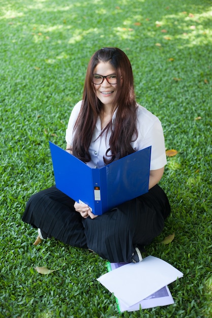 Female student sitting on the lawn