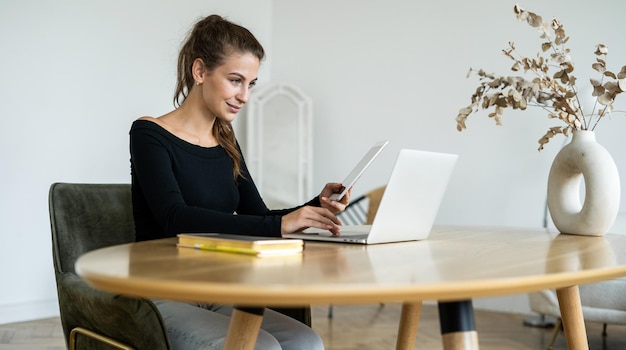 Female student studying online uses laptop coworking space place rental