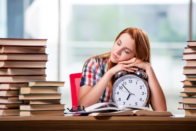 Female student with clock preparing for exams