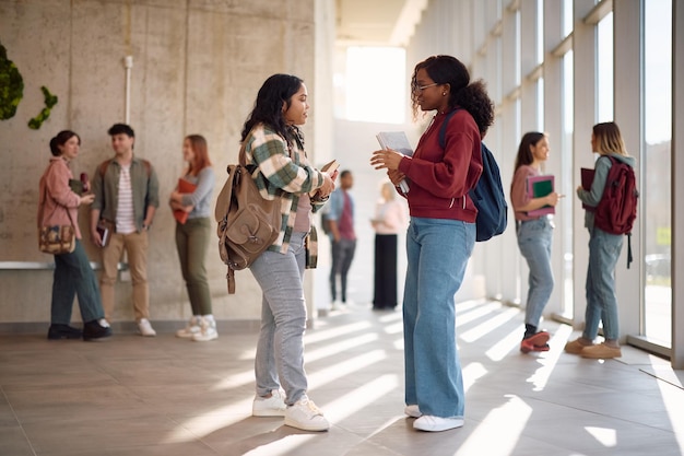 female students communicating in a hallway at the university