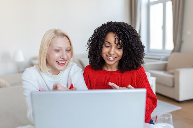 Female students cooperating together in university campus searching information for learning on internet websites via new modern laptop computer using free wifi connection indoors