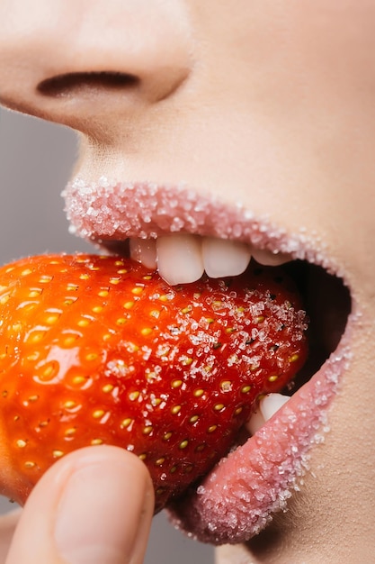 Female sugar lips bite red strawberry