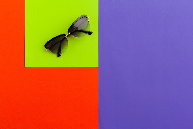 Photo female sunglasses on a color block