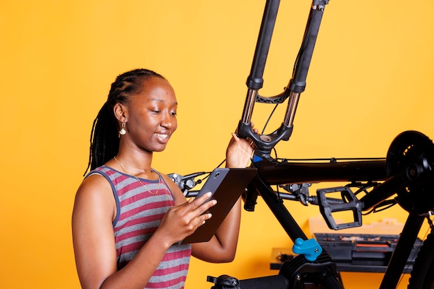 Female surfing the web to fix her bike