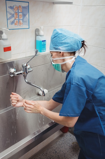 Female surgeon washing her hands