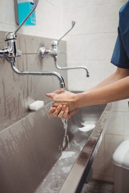 Female surgeon washing her hands