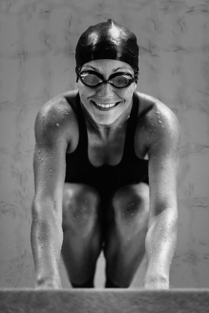 Female swimmer on pool edge