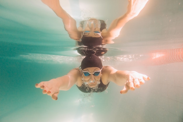 Female swimming instructor under water