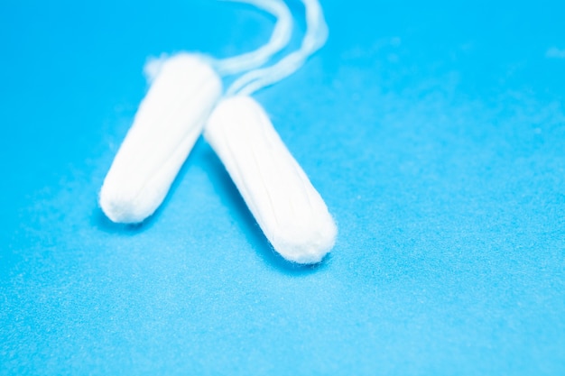 Female tampons on a blue surface