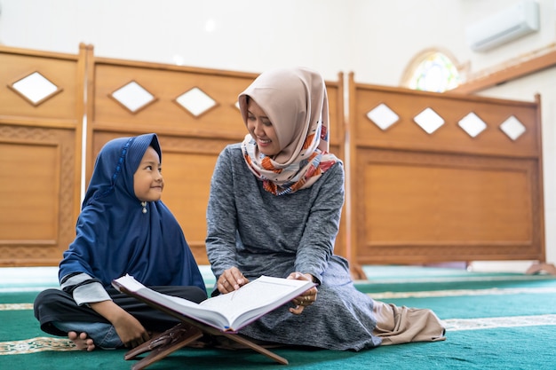 Female teacher teach her student to read Quran