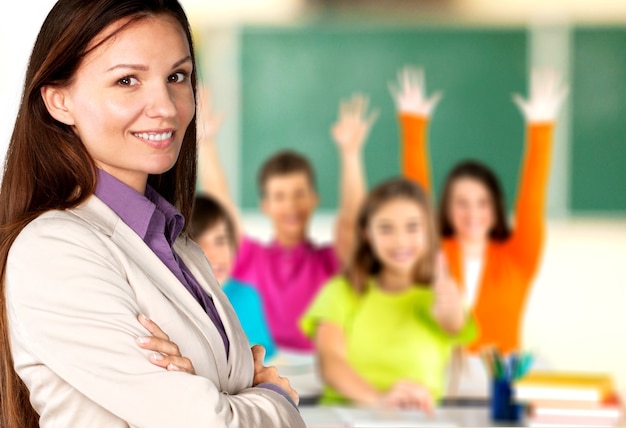 Female teacher with children at class on background