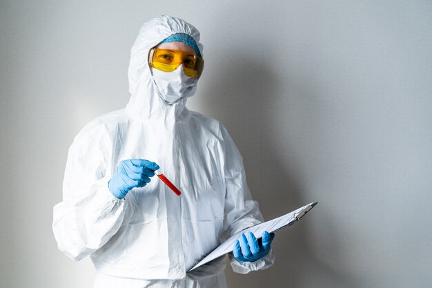 Female Technician holding blood tube test. Tubes of patients in laboratory in the hospital