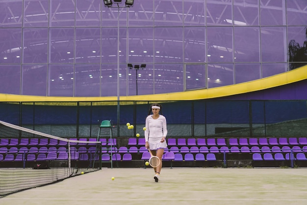 Female tennis player on green court grass