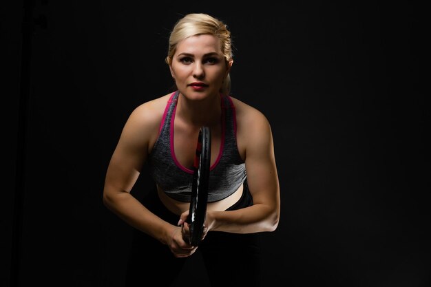 Photo female tennis player with racket and ball on black background