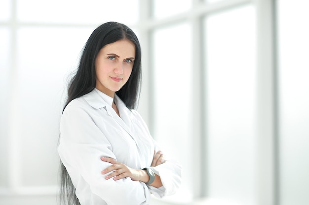 Female therapist standing by the hospital window