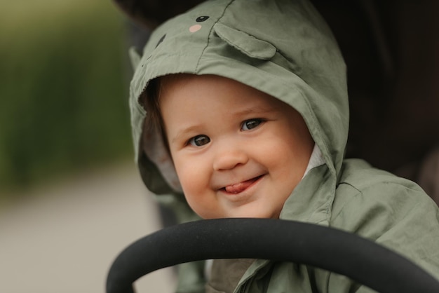 A female toddler is sitting in the stroller on a cloudy day