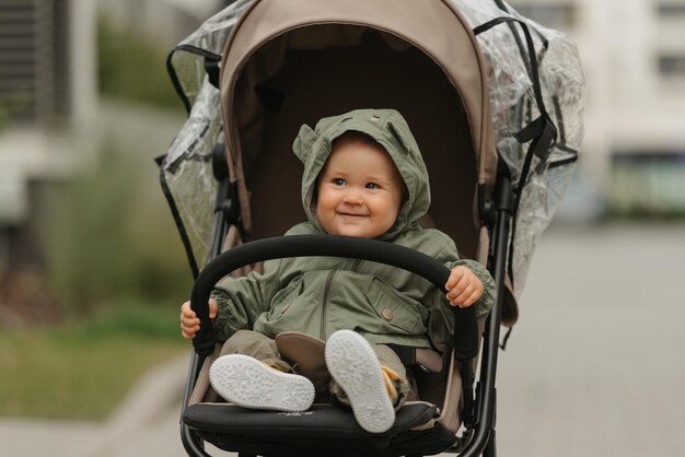 A female toddler is sitting in the stroller on a cloudy day