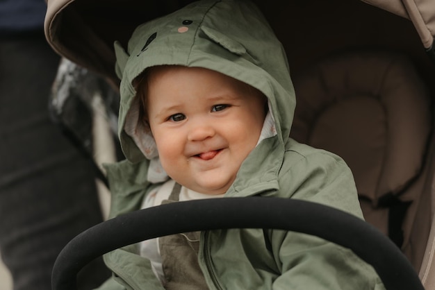 A female toddler is sitting in the stroller on a cloudy day