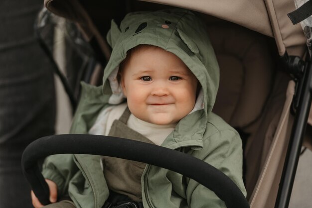 A female toddler is sitting in the stroller on a cloudy day