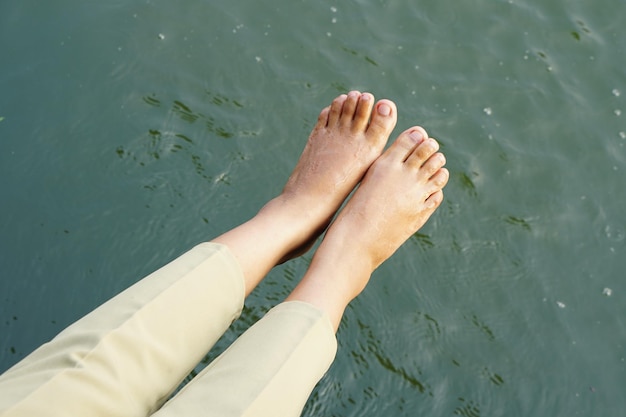 female tourist feet river background