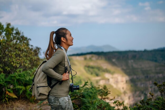 female tourist stand alone on the mountain