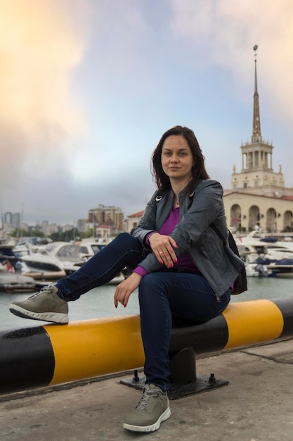 Female tourist taking a rest in a Sochi harbor