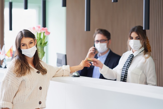 female tourist waiting at reception desk in hotel