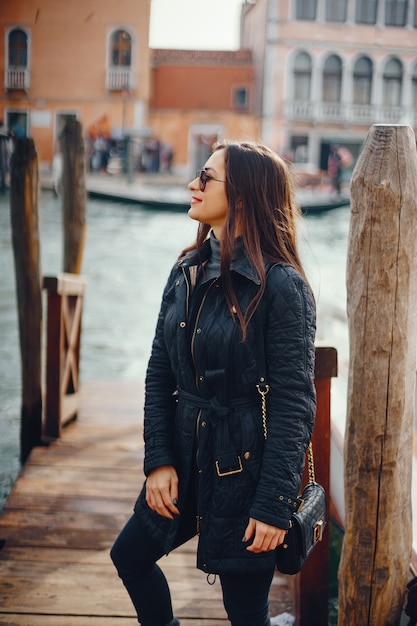 female tourist walking around and exploring venice in the early spring